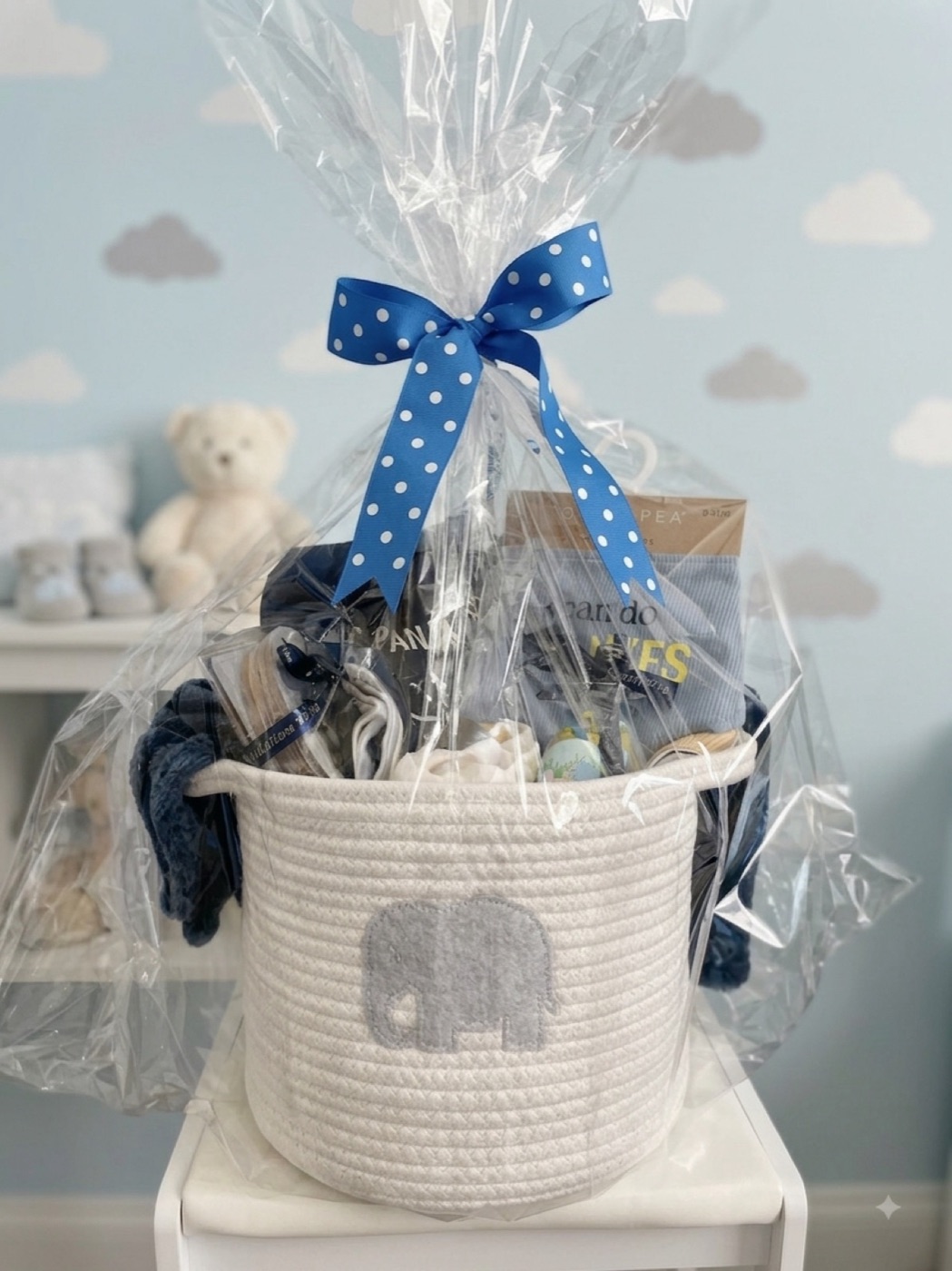 A new baby basket wrapped in cellophane and finished with a blue polka dot bow