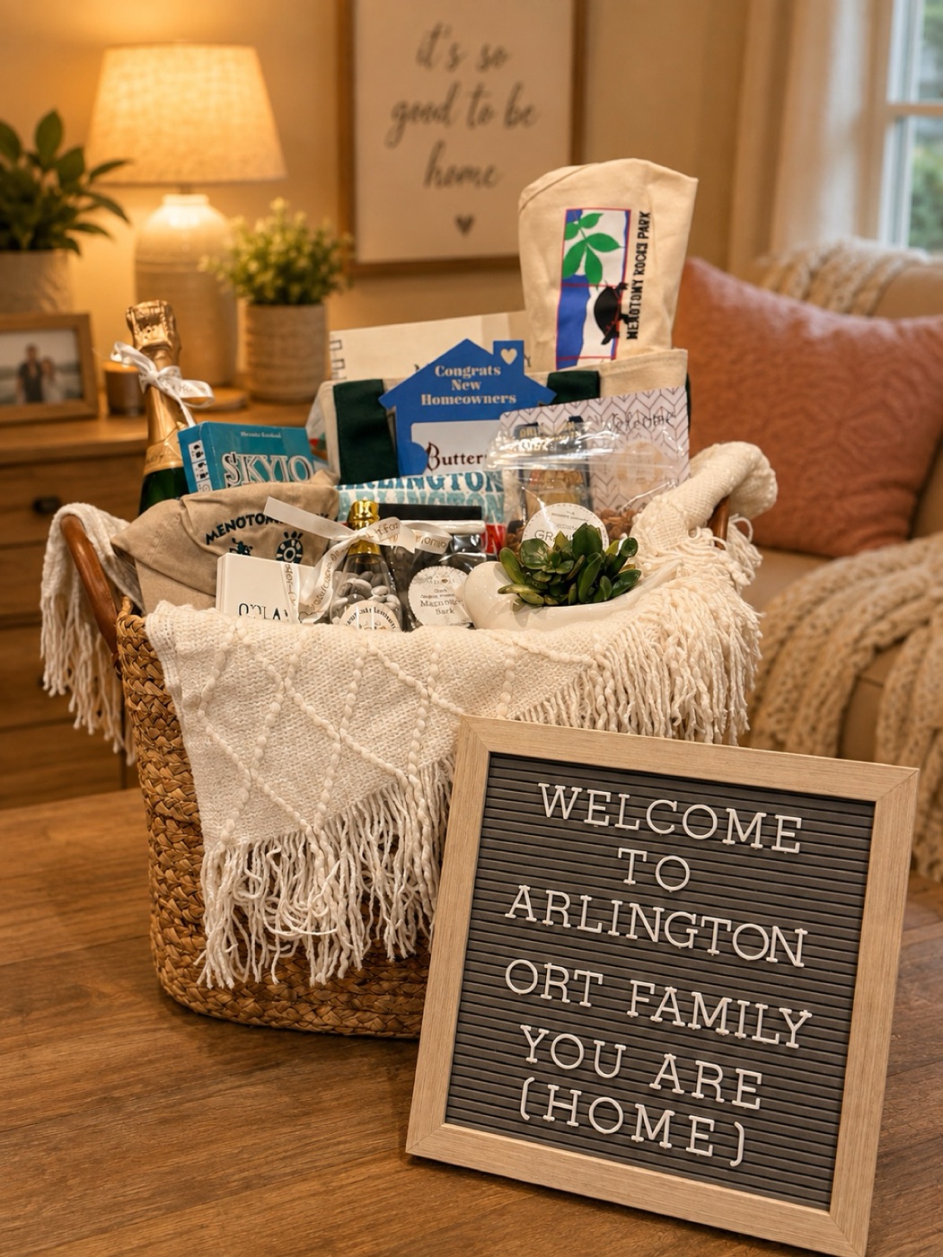 A housewarming basket with a throw blanket, local treats and a welcome letterboard